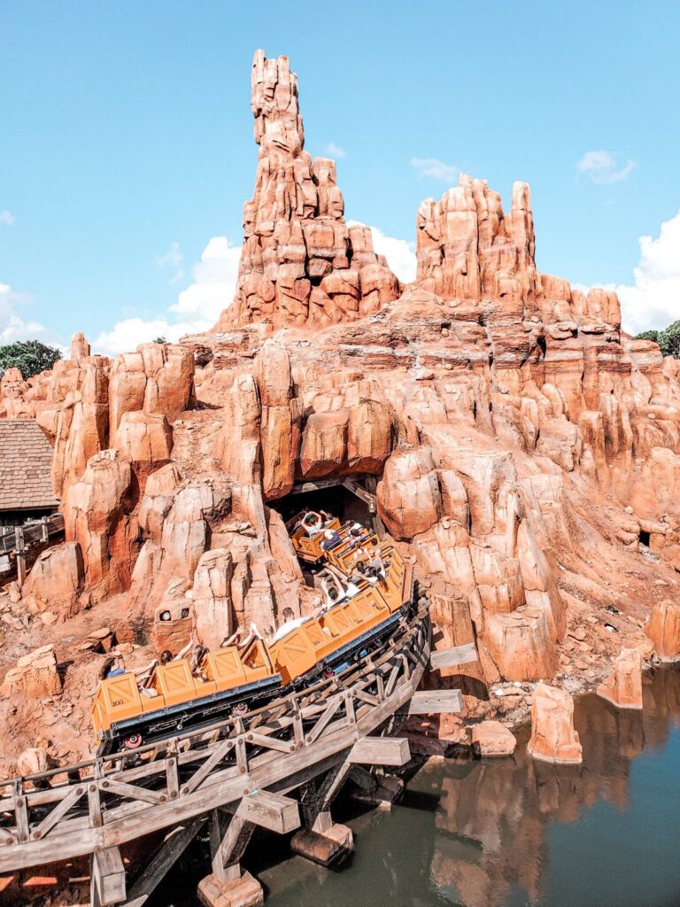 Riders with hands up on Big Thunder Mountain Railroad at Magic Kingdom, Walt Disney World