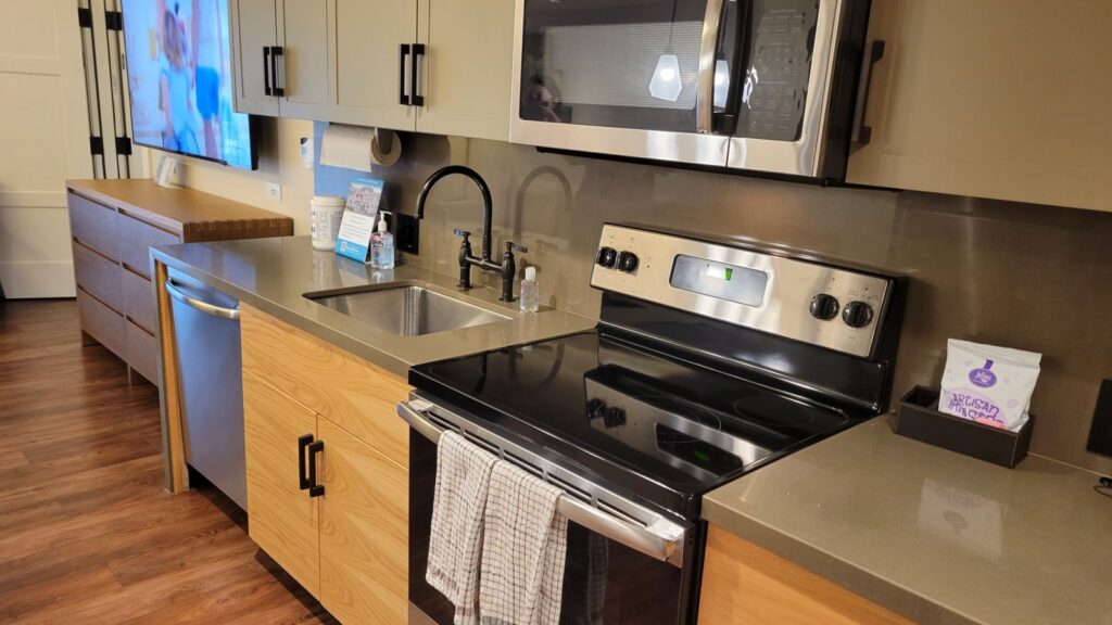 Full kitchen in a two-bedroom Cabin at Copper Creek Villas and Cabins, with a stove, dishwasher and sink