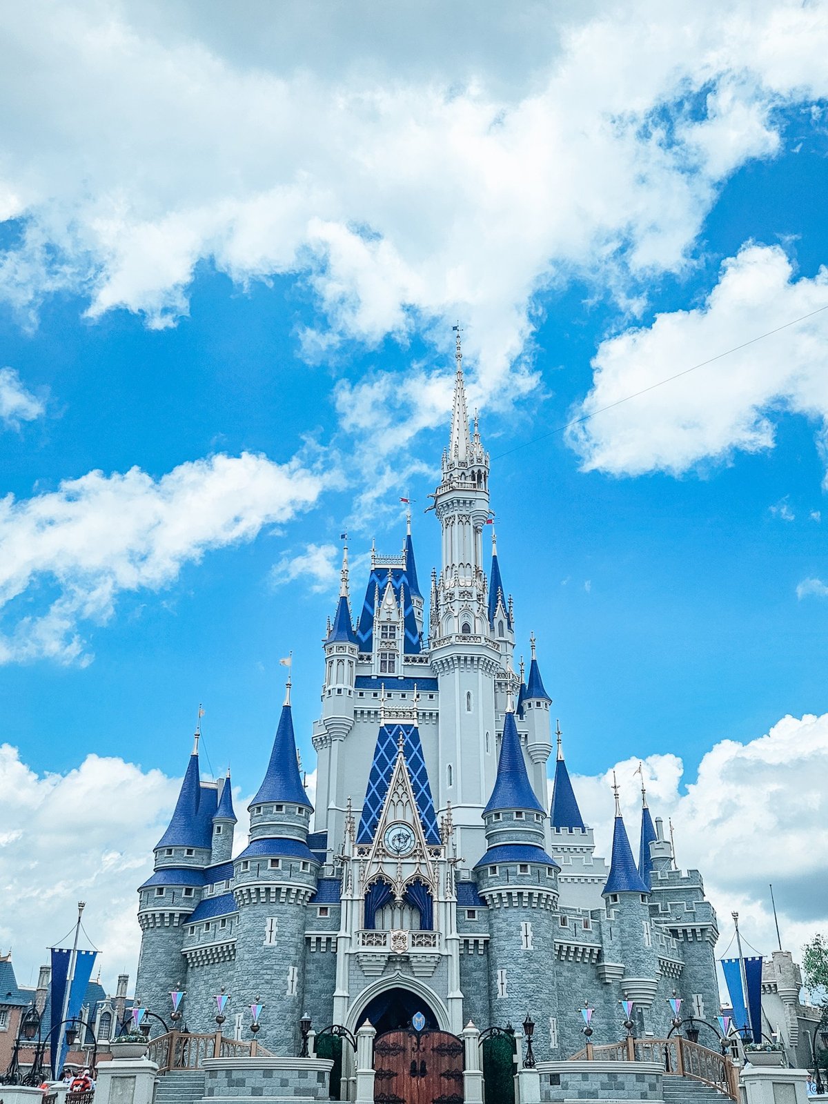 How to plan your first Disney World trip: Cinderella Castle at Magic Kingdom under a bright blue sky