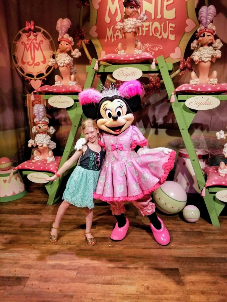 Young girl hugging Minnie Mouse at a Disney character meet and greet